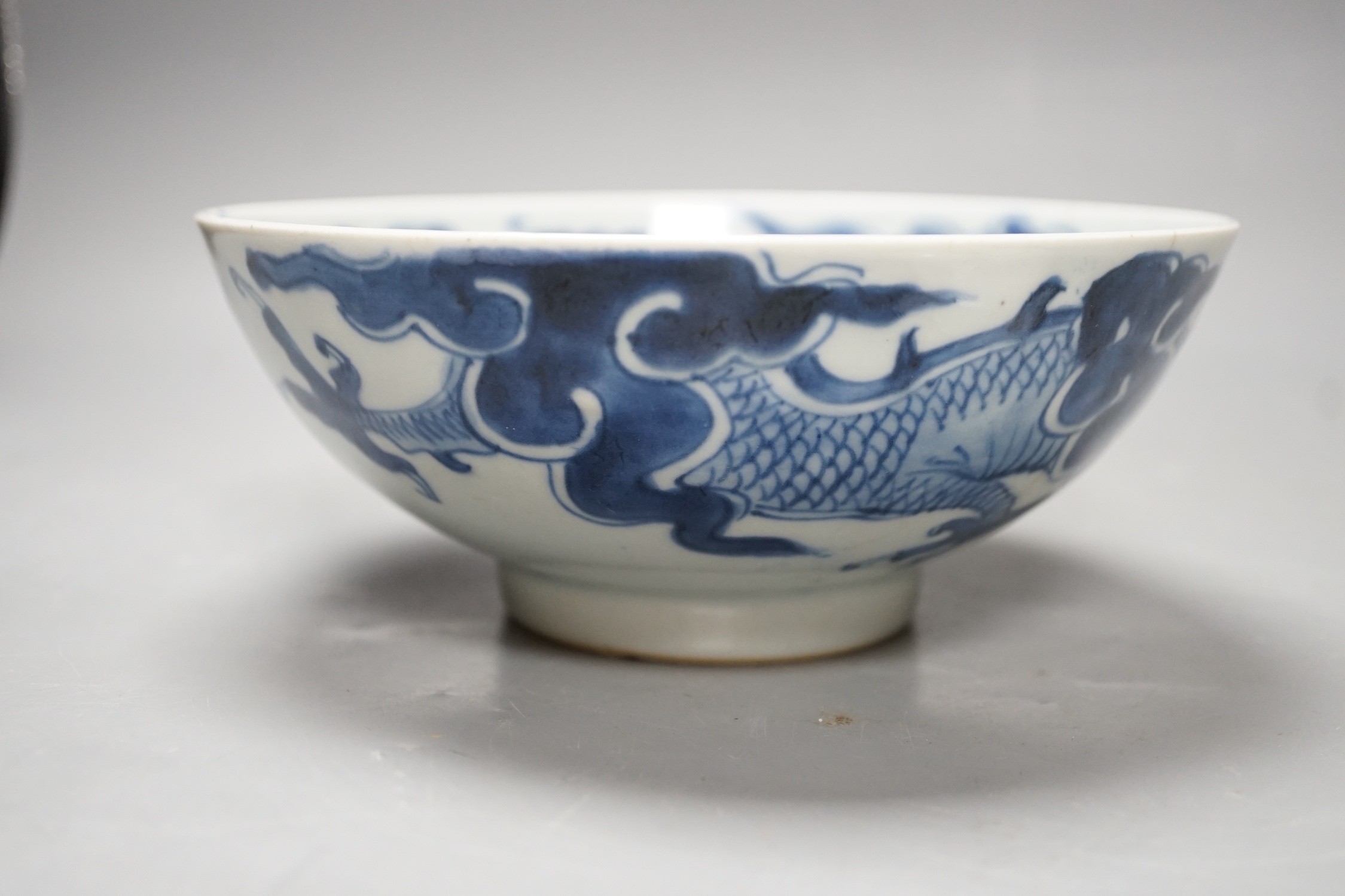 A 19th century Chinese ‘dragon’ bowl, together with a smaller ‘dragon’ dish. Largest 18.5cm diameter